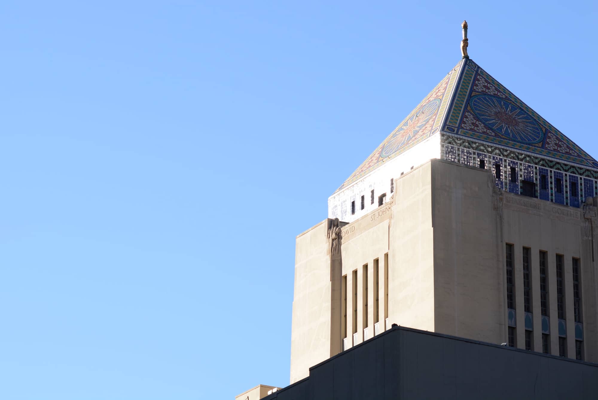 The tiled mosaic pyramid and carved stone tower of the Los Angeles Central Library against a blue sky, an emblem for a list of the best architecture books