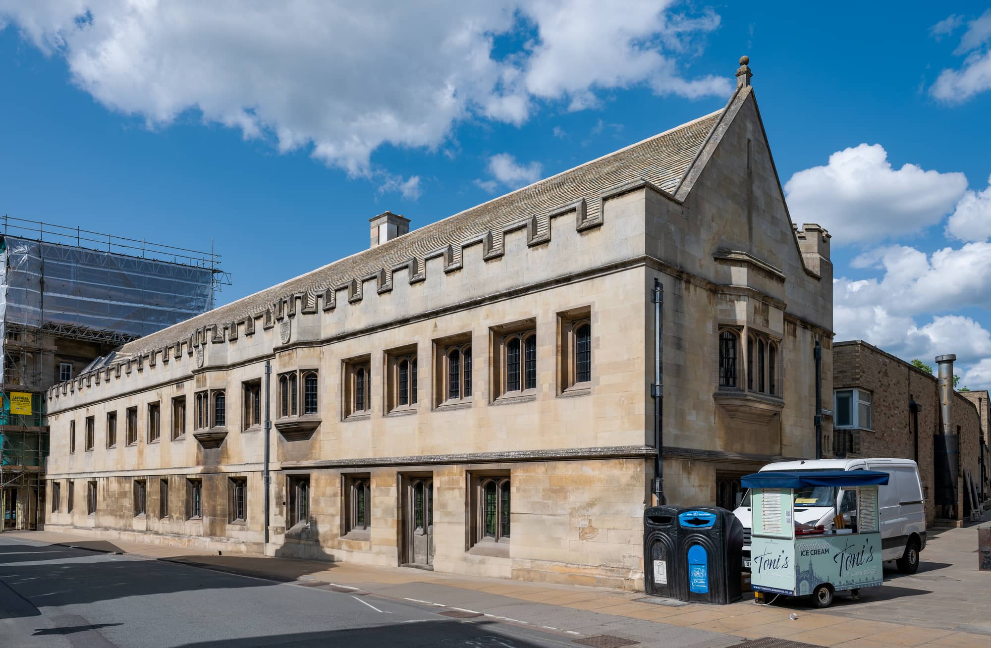 The stone street range of Christ's College on St Andrew's Street, Cambridge, in June 2025, a two-storey battlemented building with mullioned windows, near the site of the Christ's College library plans