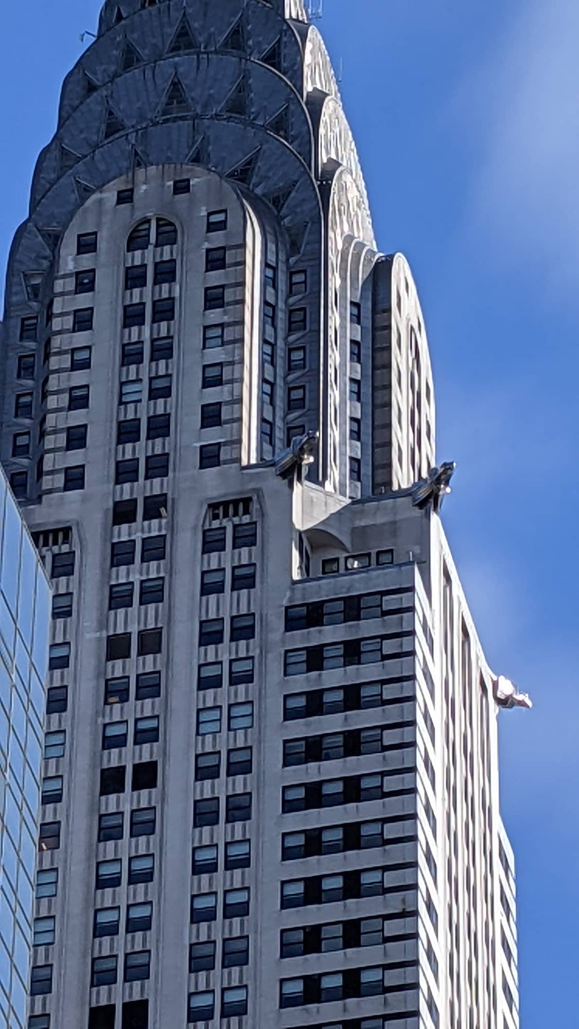 A steel eagle gargoyle projecting from a corner of the Chrysler Building's 61st floor, high above Manhattan